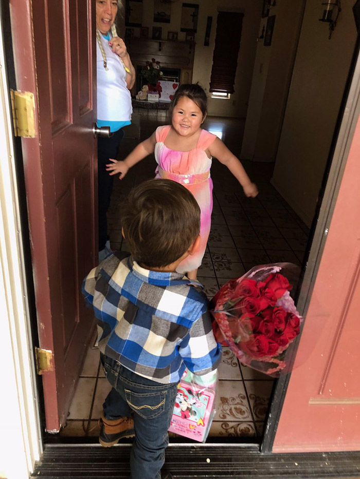 little boy so happy to give girlfriend gift on valentines day