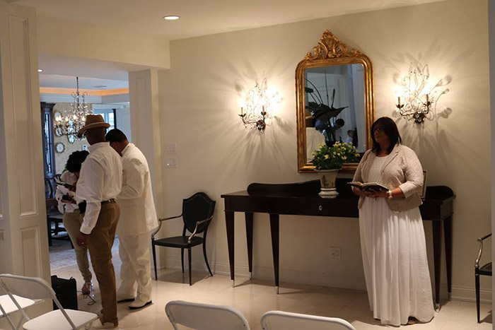 couple invites wedding guests into home when it rains on beach