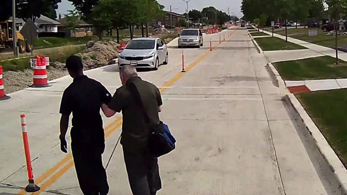 bus driver helps blind man cross the road