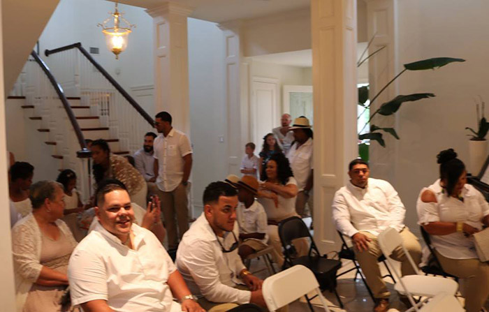 couple invites wedding guests into home when it rains on beach