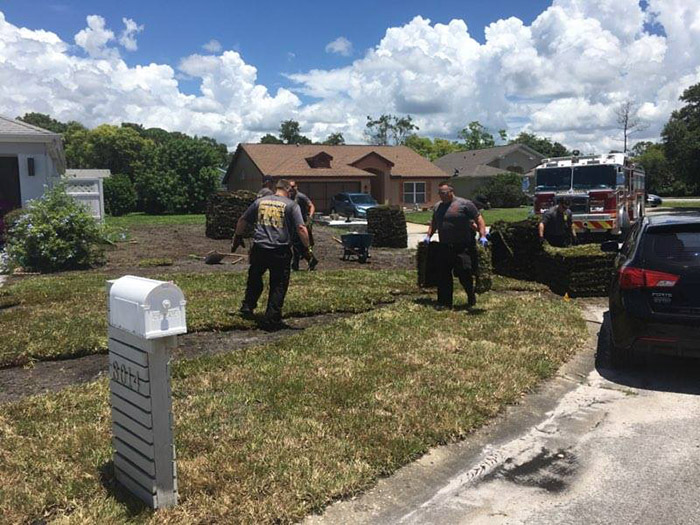 firefighters finish laying sod for man heart attack
