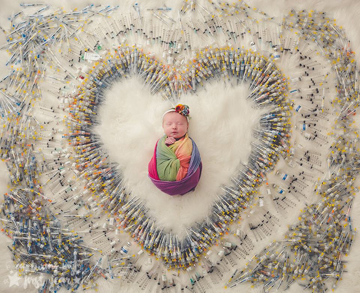 baby surrounded by IVF syringes