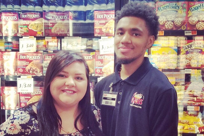 grocery store employee lets boy with autism help him stock shelves