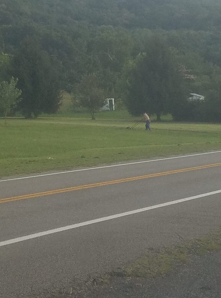 lawn service cuts lawn for free man pushing mower