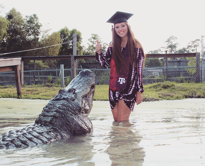 college grad poses with alligator
