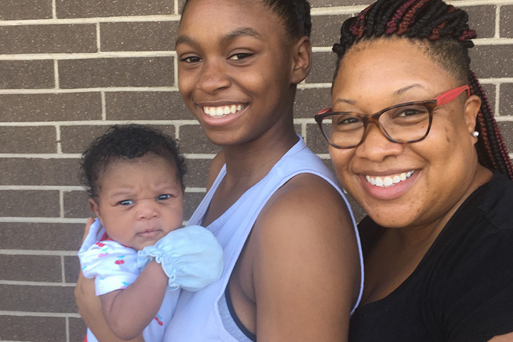 teacher holds baby in car former student job fair