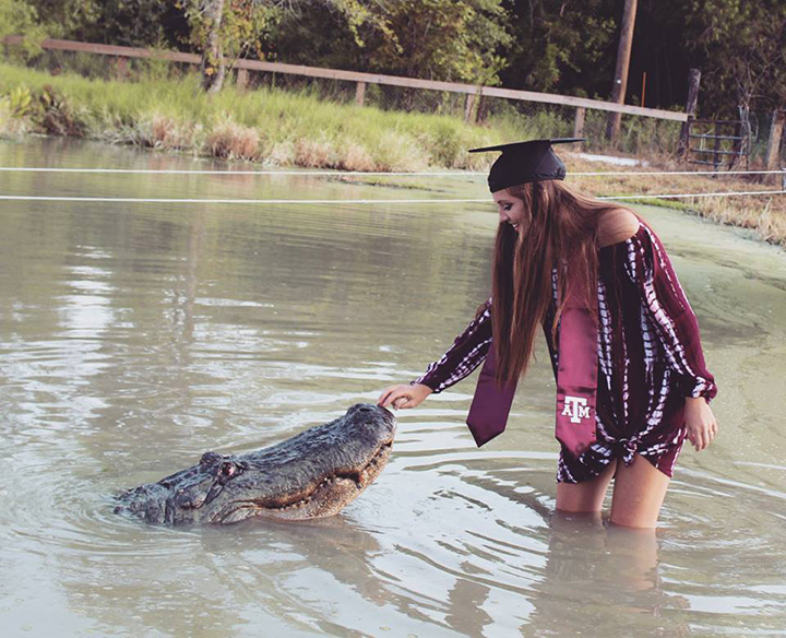 college grad poses with alligator