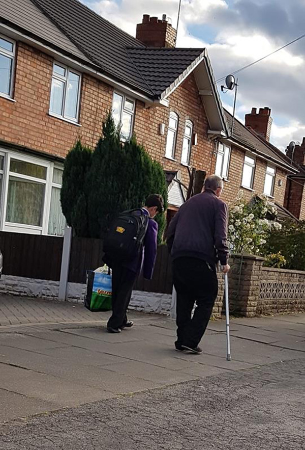 little boy asks old man to carry bag