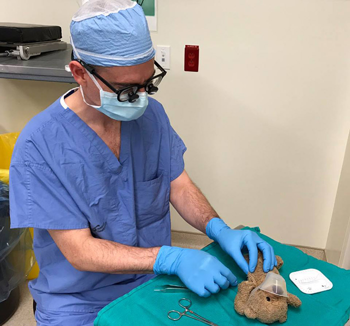 surgeon operates on teddy bear