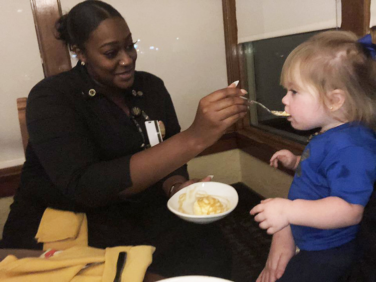 waitress feeds kid so parents can eat