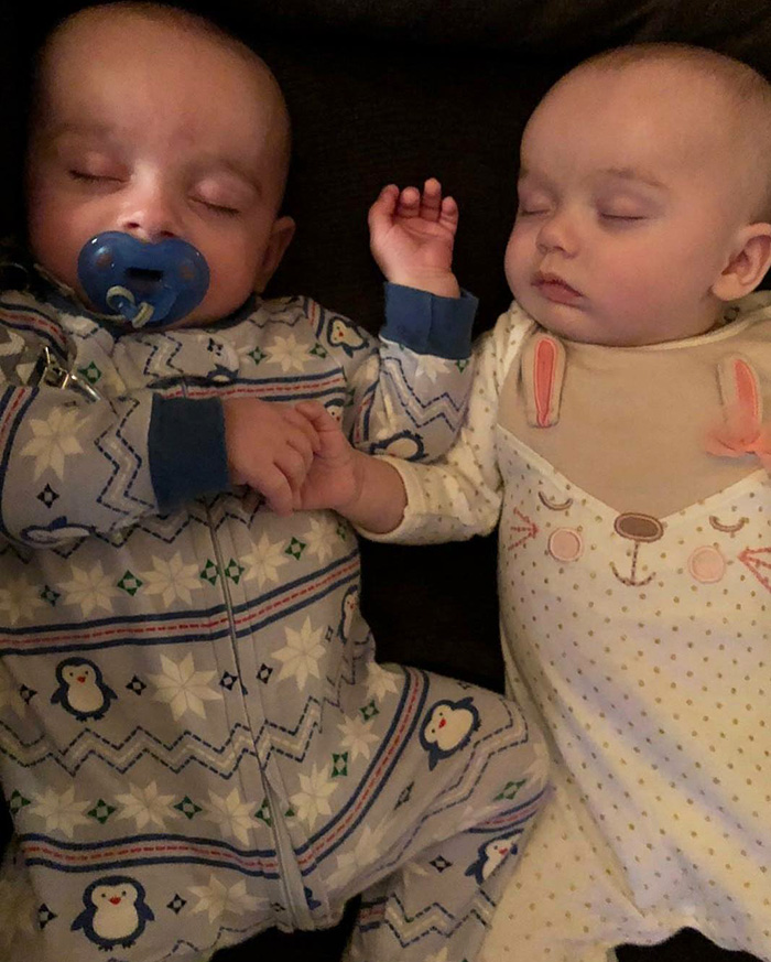 twins fall asleep holding hands