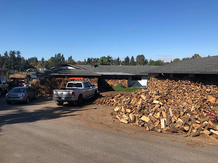 father and sons chop wood for needy