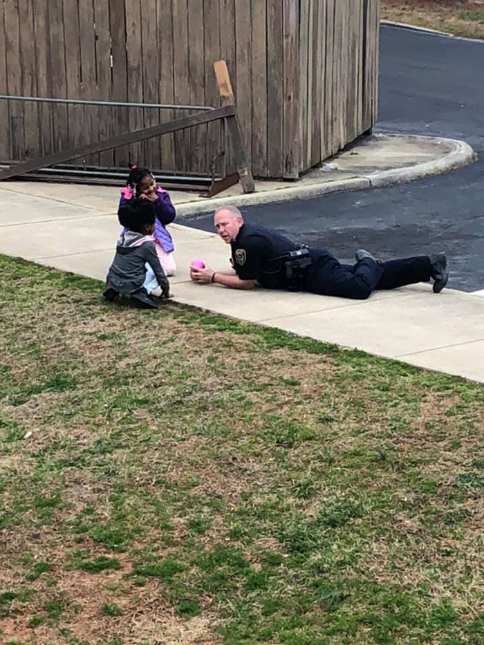cop plays dolls with girls