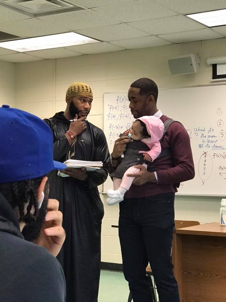 professor holds baby