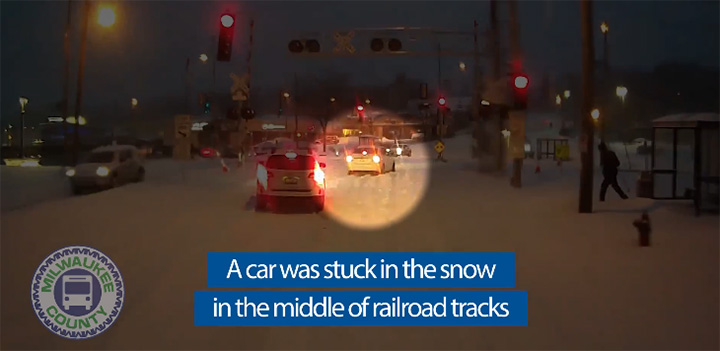 bus driver pulls over to help car in snow