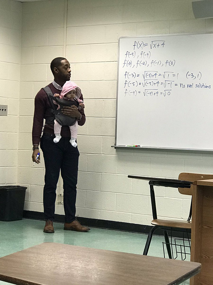 professor holds baby in class