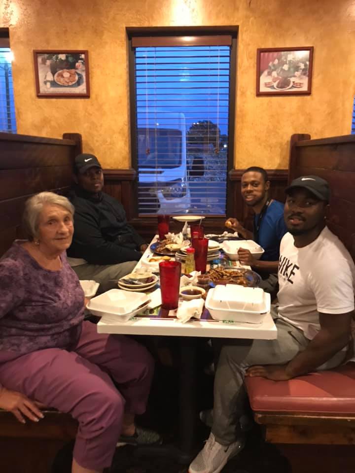 men sit with women eating alone