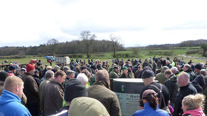 farmers stand in silence at auction