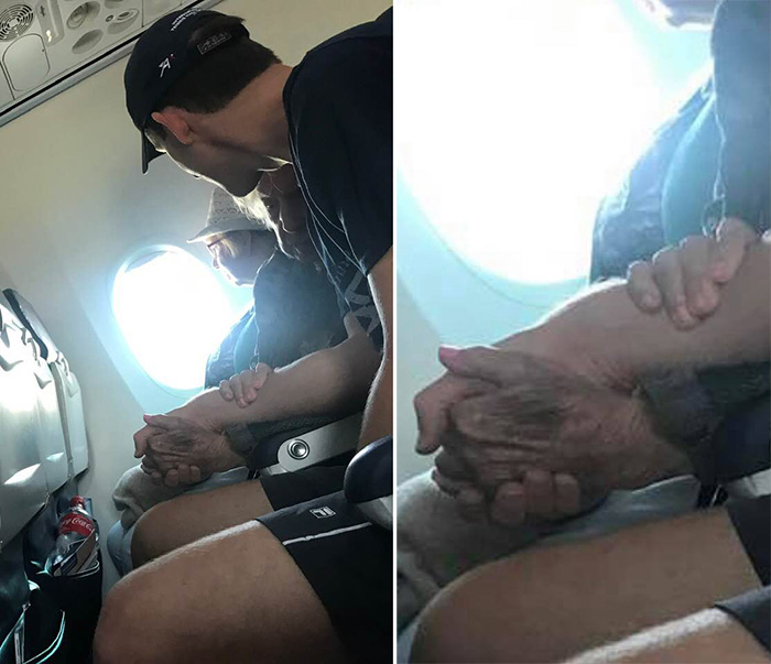 man comforts elderly woman on flight