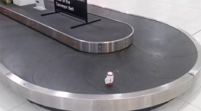man checks single can of beer airport