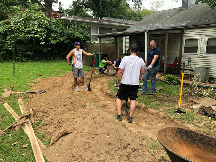 firefighters build woman in wheelchair a sidewalk