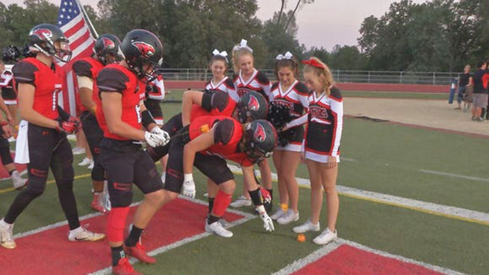 football team supports cheerleader cancer roses
