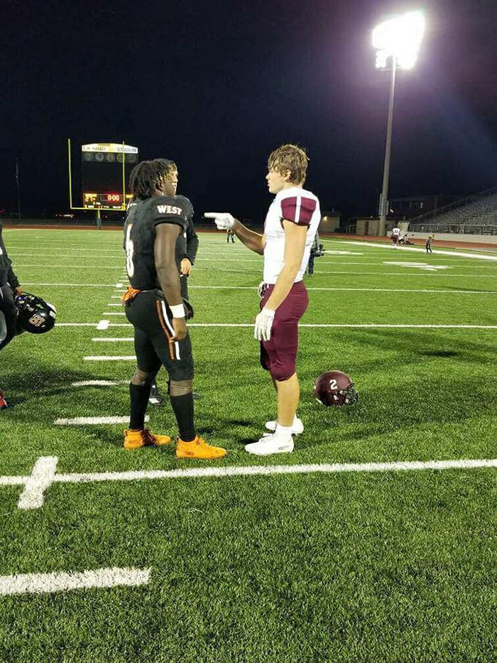 football players pray together