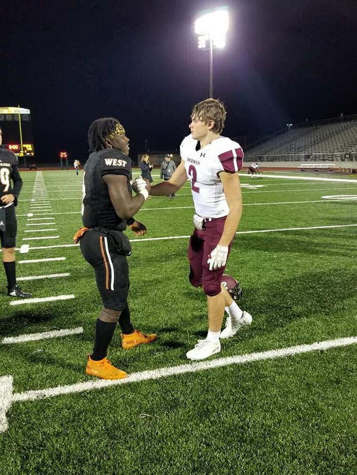 football players pray together