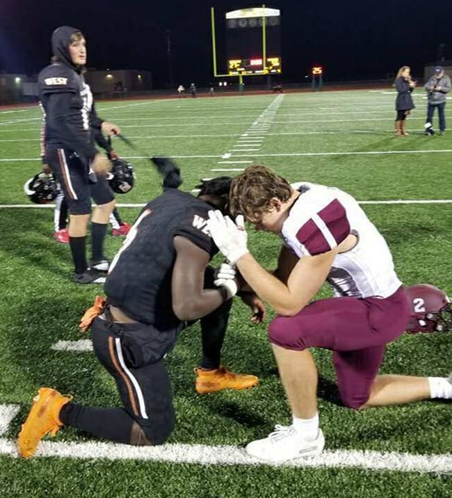 football players pray together