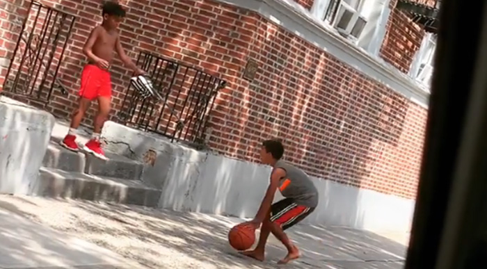 kid gives boy shoes to play basketball