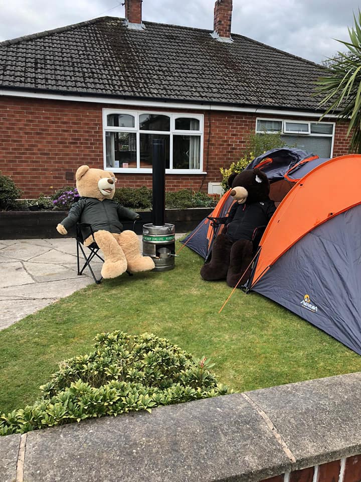 man poses giant bears to bring smiles