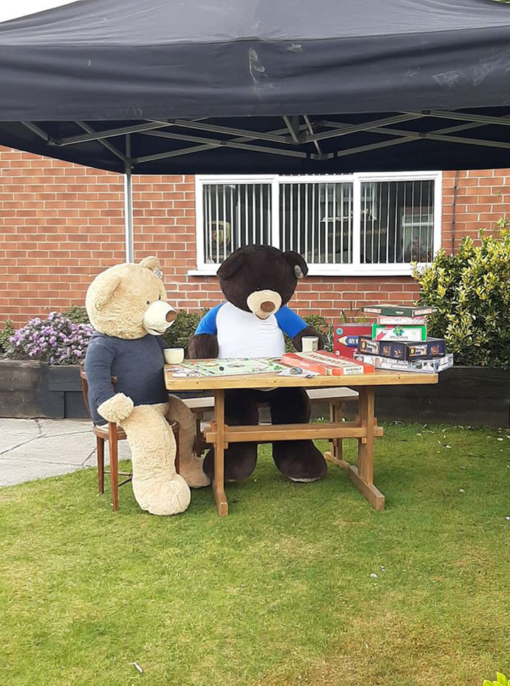 man poses giant bears to bring smiles