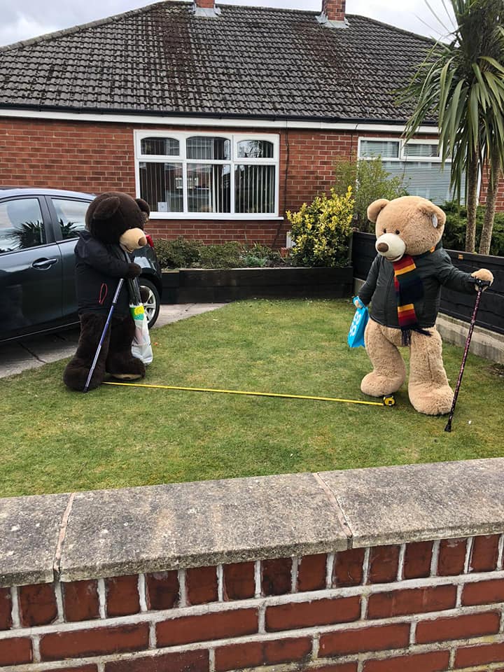 man poses giant bears to bring smiles