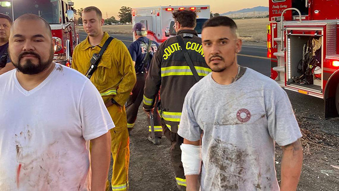 men rescue woman sinking car