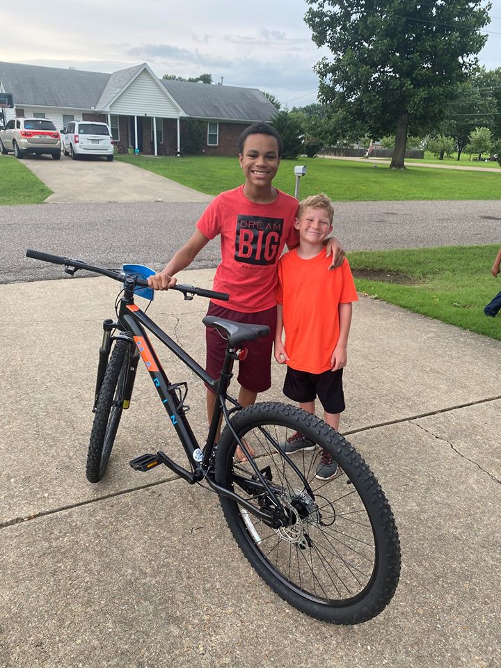 boy gives bike to neighbor