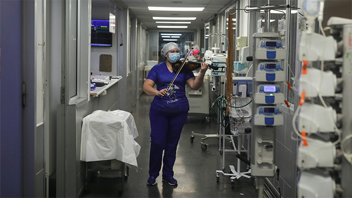 nurse plays violin for patients