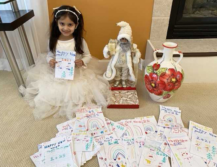 girl sends New years cards to seniors