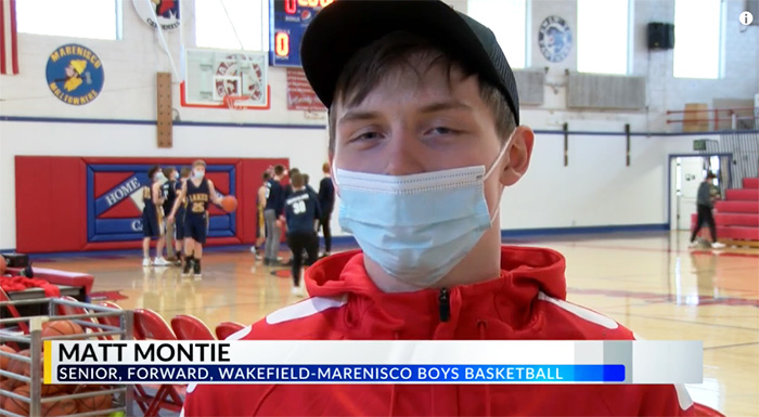 basketball players gives shoes to opposing player