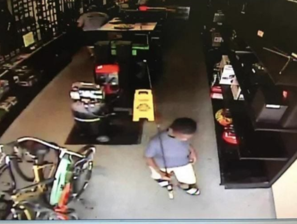 store owner gifts kid fishing rod