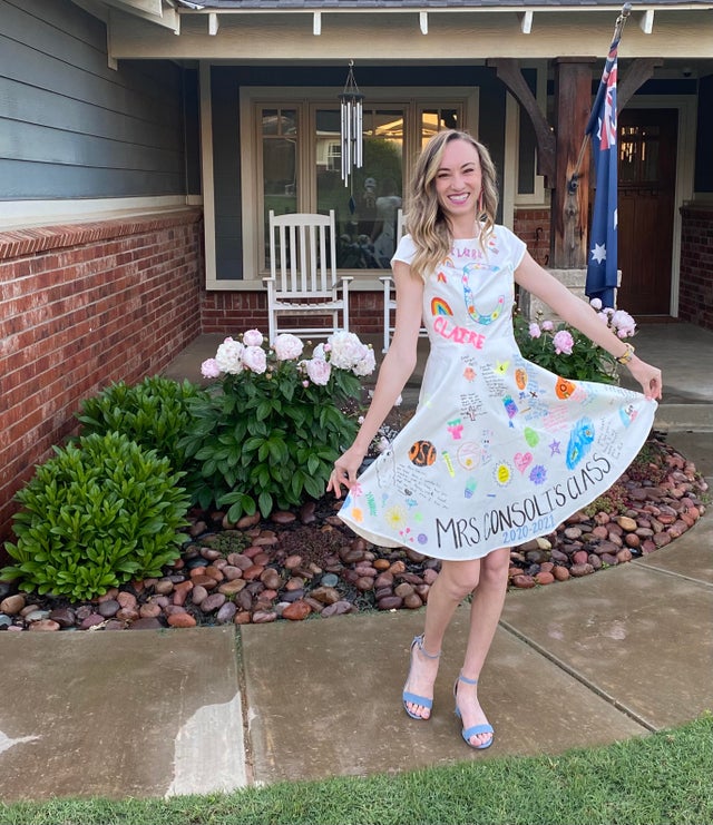 teacher wears dress decorated by students