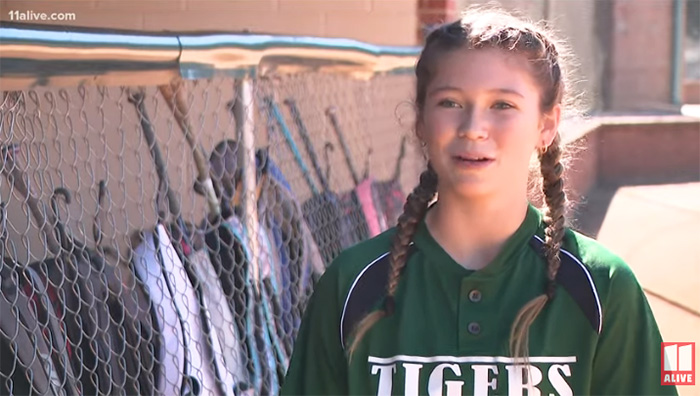 softball player helps opposing team