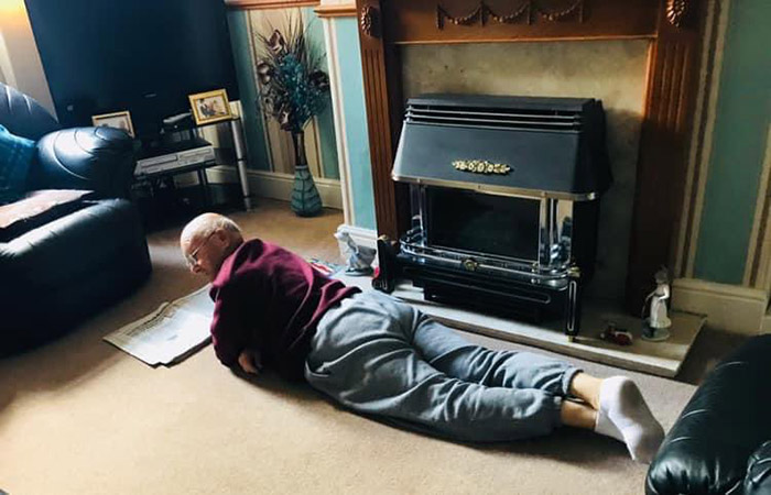 dad 91 reads newspaper on floor