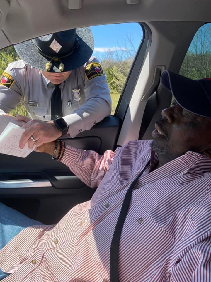 police officer prays for man