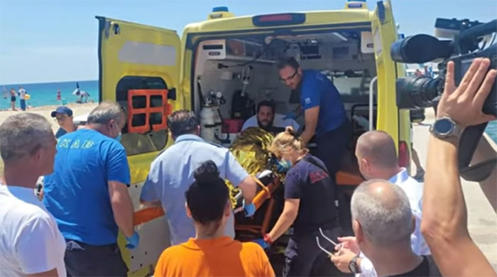 man survives 18 hours at sea holding soccer ball Greece