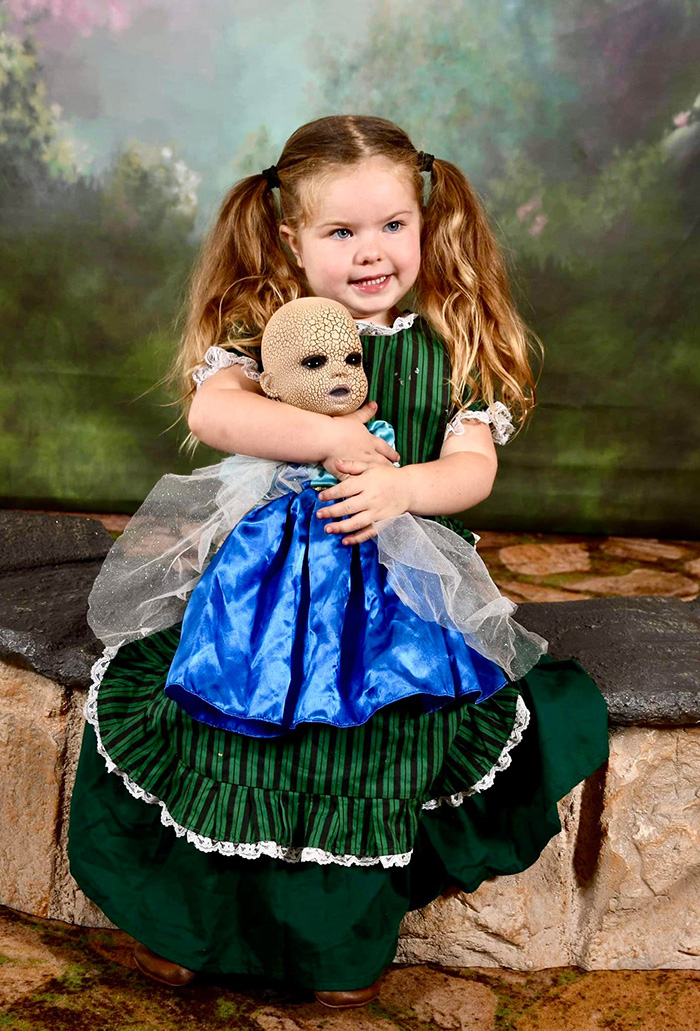 little girl loves her creepy doll