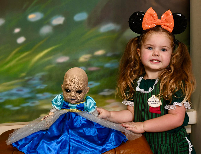 little girl loves her creepy doll