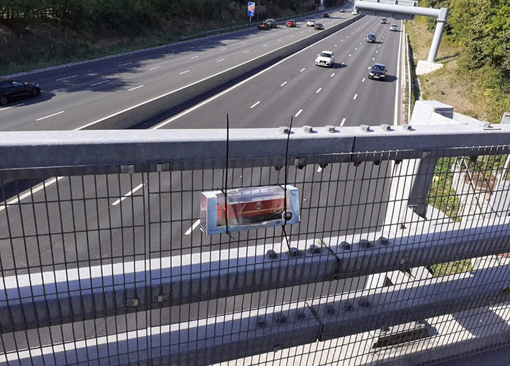 truck driver leaves toy truck for waving man on bridge