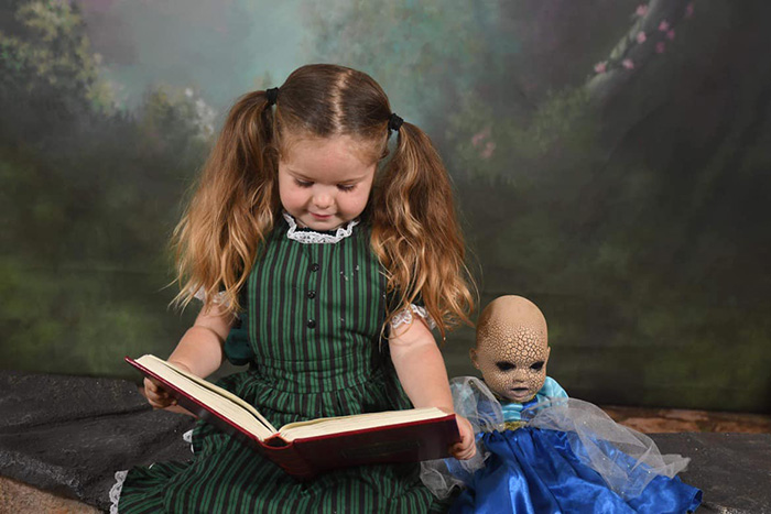 little girl loves her creepy doll
