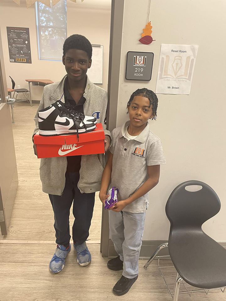 kid gives new shoes to bullied student