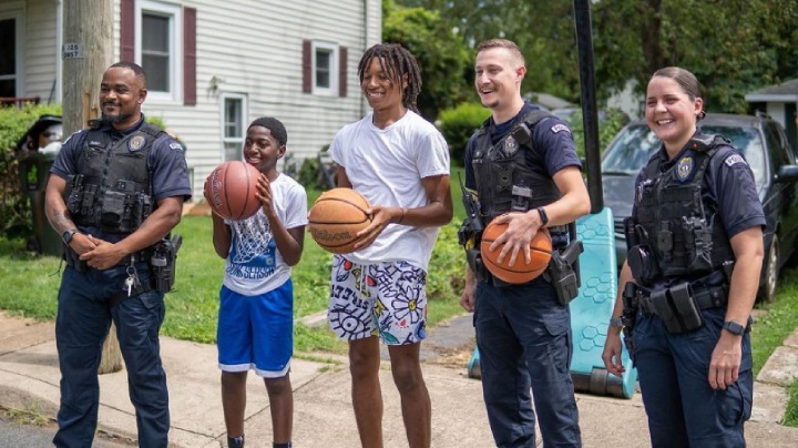police play basketball with kids in community
